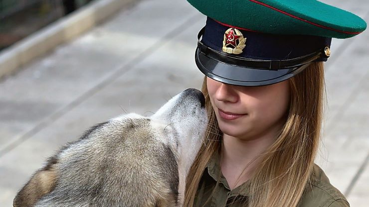 A Russian girl looking in the eyes of a Russian dog